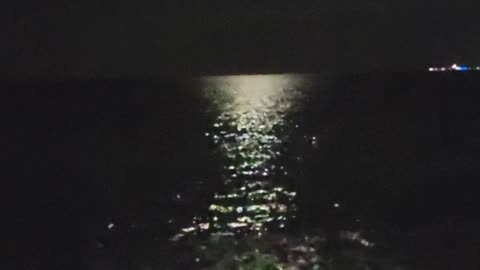 moonlight on the ocean as the waves come in at the beach at Secrets Resort in Playa Mujeres, Mexico