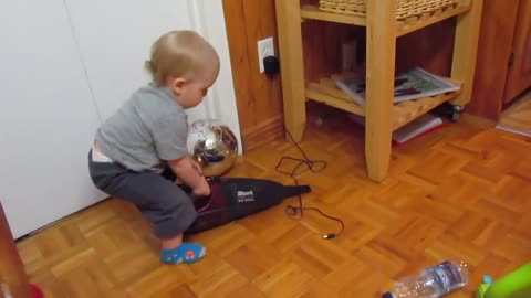Baby plays with dustbuster!