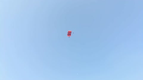 brave parachute jumping on the building