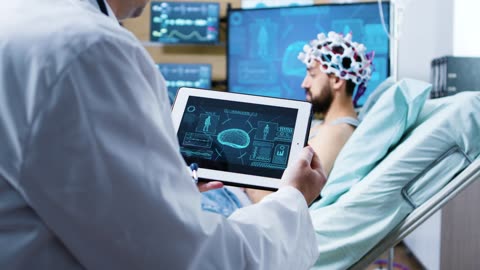 Doctor views 3D brain scan on tablet in modern clinic