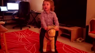Two year old really likes his wooden horsey.