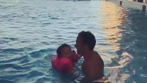 father and his son in swimming pool vacation