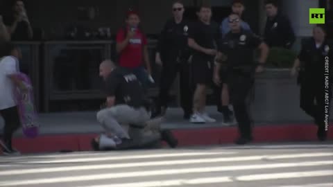 Tuff Guy Cop Treatened by Lady with a bullhorn as motorcade passes by