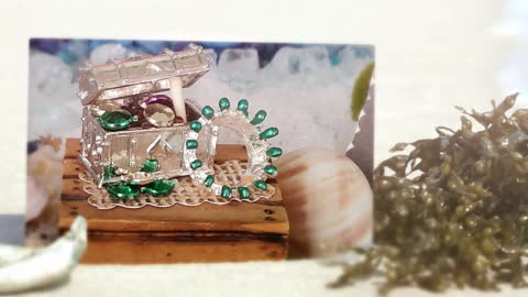 Pirate Silver Metal Chest With Jewels Or A Silver Crown Tipped In Green