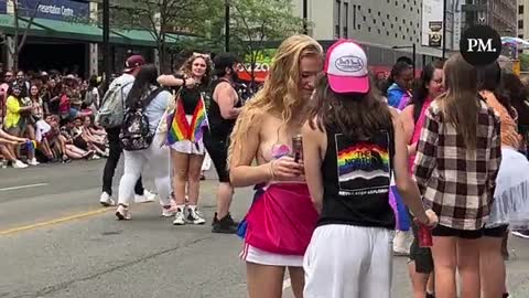 Half naked woman dances in front of children at Toronto Pride parade
