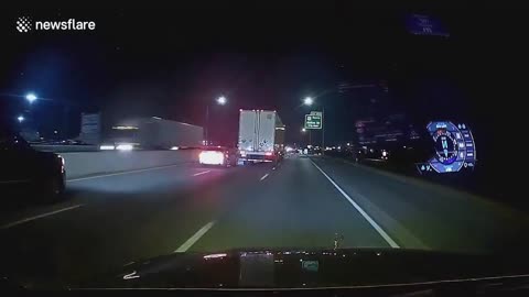 Drifting car nudges truck and slams into concrete barrier