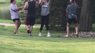 Three people trying to pull guy up a tree with rope rope snaps and everyone falls on the floor