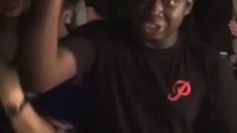 Guy black shirt trying to open beer with head and fails