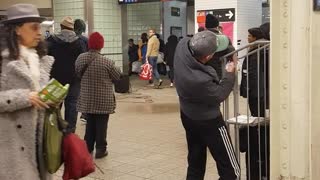 Man dances by himself to live band music in subway station