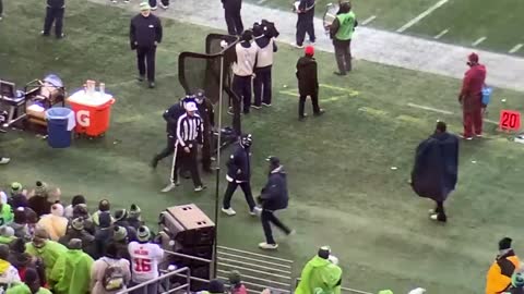 Referee Tony Corrente helped into the Seahawks’ locker room