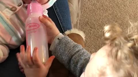 Adorable Big brother Feeds Baby Sister Bottle