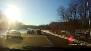 Cars nearly collide on highway lane merge