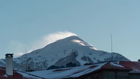 Nice Time Lapse Video of a Snow Covered Mountain.