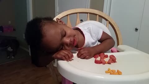 Adorable baby girl falls asleep while eating