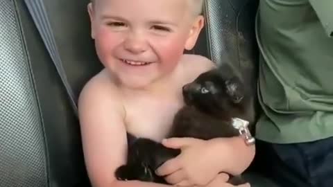 The cutest thing you will see today,funny little kid hold a cute black cat