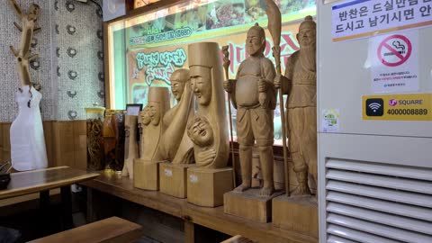 Wooden dolls on display in Korean restaurants