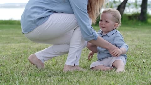 Beautiful baby boy walking on the grass