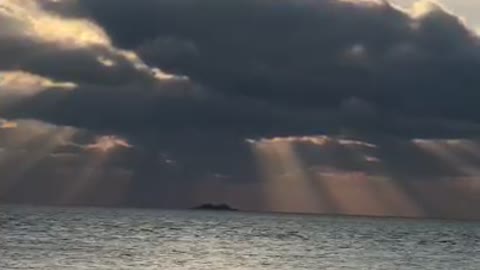 the sun hidden by clouds on the horizon