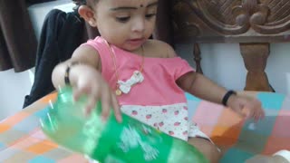 cute baby playing with 7up bottle