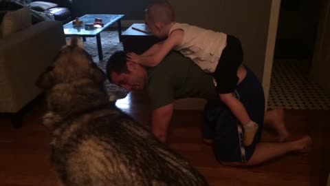 Cute moment between dog, dad and son