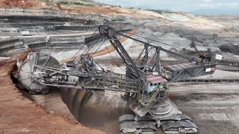 Huge Wheel Bucket Excavator Working On Coal Mines - Aerial View - 4k