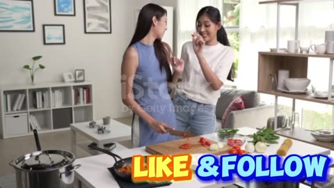 Romantic Asian lesbian couple is cooking on kitchen