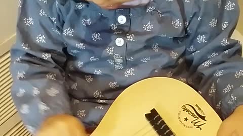 Toddler playing guitar