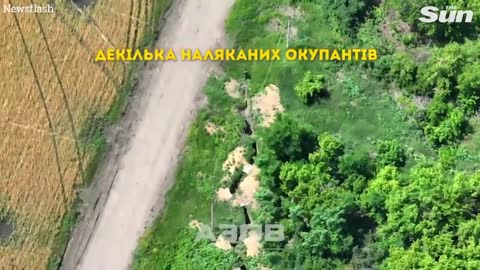 Ukrainian troops use drone to drop bomb on Russian soldiers in a trench