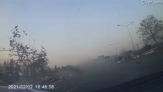 Car Rolls Through Light Post and into Traffic