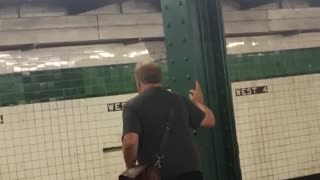 Guy holding onto green pillar subway doing squats