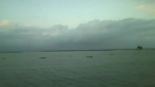 A wonderful view of the sea coast at dusk, beach, buildings, boats and an island! [Nature & Animals]