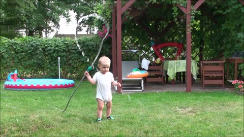 Baby watering the grass