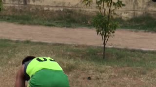 Guy green track outfit shorts tries to do handstand walk on bars falls forward on feet