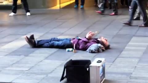 Beatboxing Busker Performs for Supine Spectator