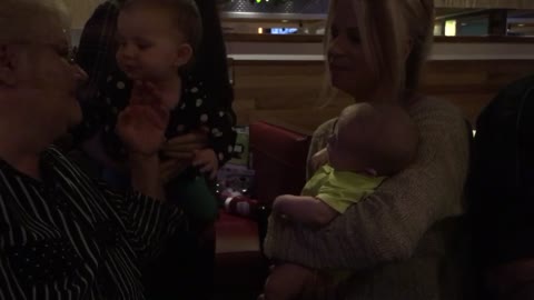 Adorable baby kisses her baby cousin