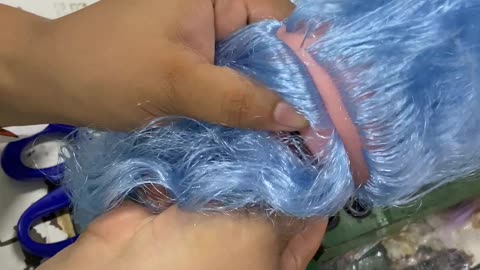 Doll Gets Blue Hair Sewn On