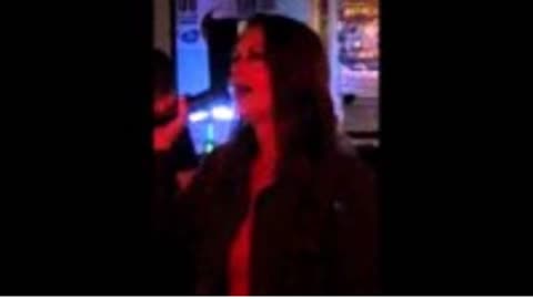 Glendia Turner singing at karaoke night
