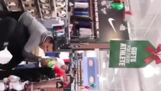 Three kids play dodgeball in large store