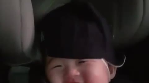 Sweet baby laughs in adorable manner