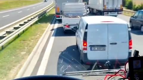 Truck drivers repair cars when stuck on the highway.