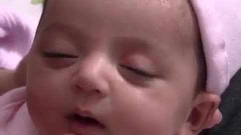 Cute baby smiling while sleeping
