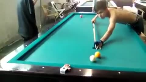 The old man plays Billiard with one hand