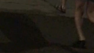 Kids crossing road with black surf board