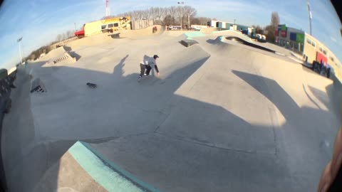 Skater grinds a blue curb and falls, lands on face