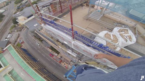 Daredevil climbs on top of crane without harness