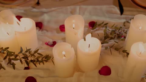 a romantic dinner table adorned with lit candles rose