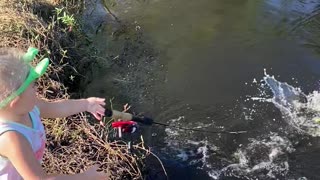 Daughter Reeling in First Fish Drops Pole