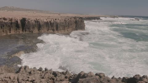 View of High Waves Splashing on the Bed of Rocks