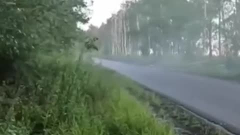 A soldier of the Armed Forces of Ukraine shoots a column of e Russian