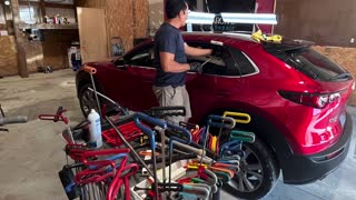 Paintless dent repair on a customer's vehicle